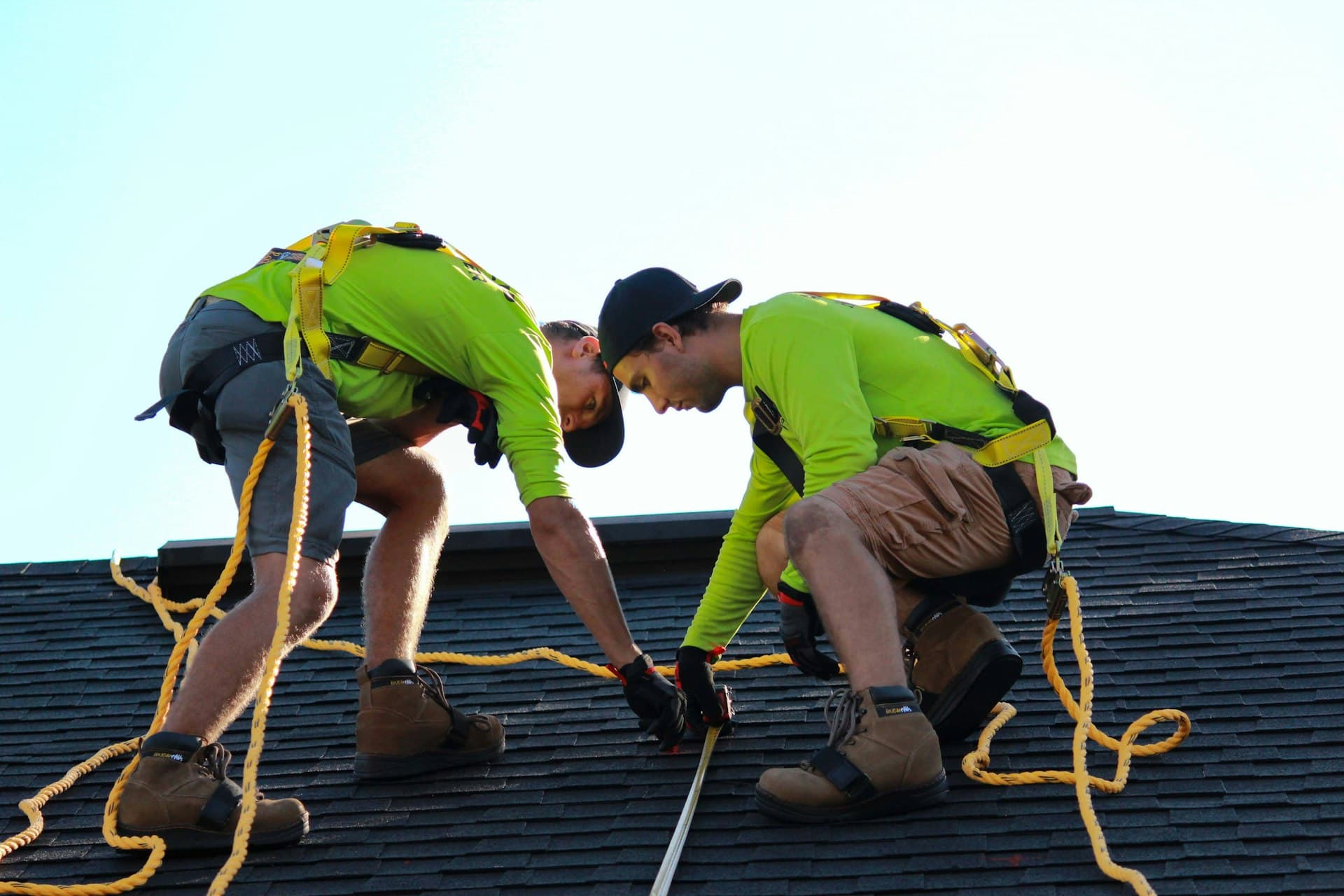 Solar installation workers maintaining panels on a commercial rooftop